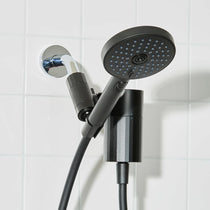 Black shower head and handheld shower on a tiled bathroom wall