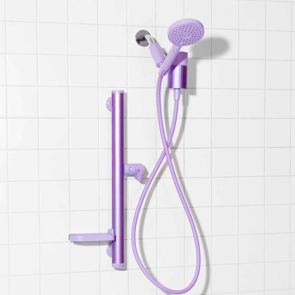Purple shower head and hose set on a tiled wall background